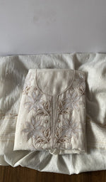 Folded white pure mul chanderi kurta piece with chikankari on the panel