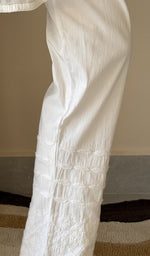 Chikankari at the hem of the white cotton pant, close up