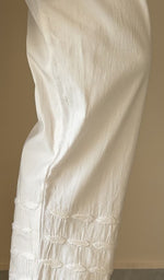 Hem embroidery on the white pant, up close