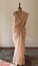 Peach pure silk georgette saree draped on the mannequin