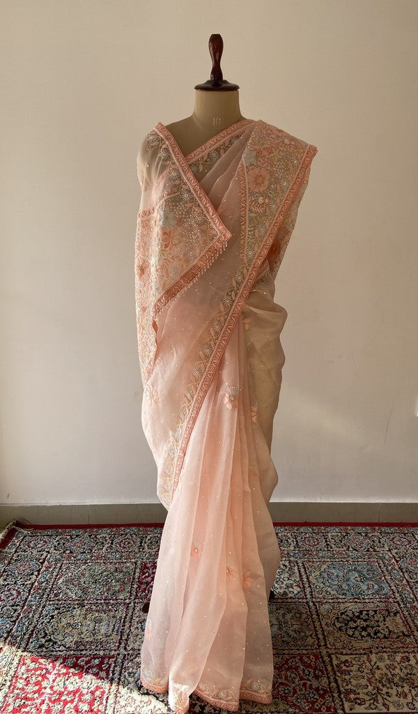 Peach pure silk georgette saree draped on the mannequin