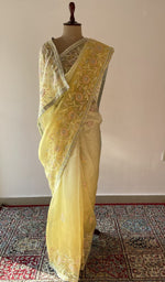 Yellow pure silk georgette saree draped on the mannequin