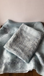 Folded grey pure organza silk kurta piece with chikankari on the panel