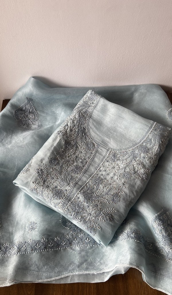 Folded grey pure organza silk kurta piece with chikankari on the panel
