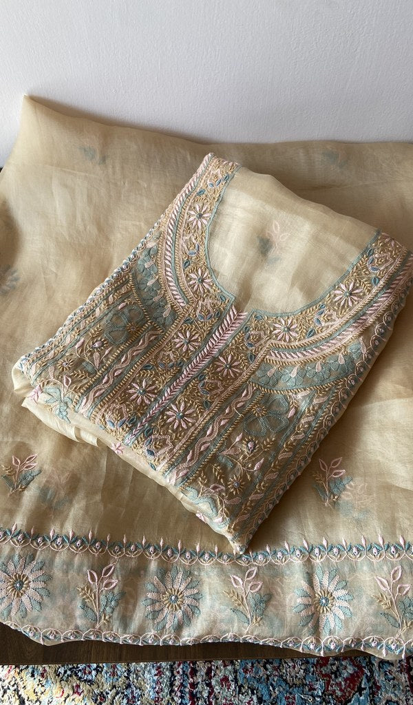 Folded beige pure organza silk kurta piece with chikankari on the panel
