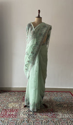 Green pure organza silk chikankari saree draped on the mannequin