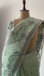 Border and hem of the green saree