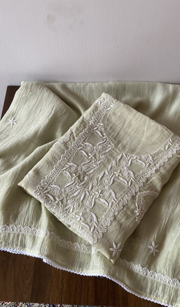Folded green pure mul chanderi kurta piece with chikankari on the panel