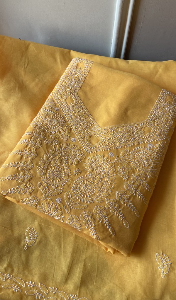 Folded mustard yellow cotton kurta, front view