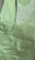 Pista green cotton laid out flat
