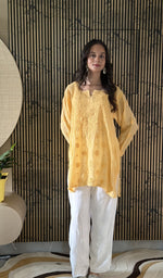 Yellow muslin short kurti on the model