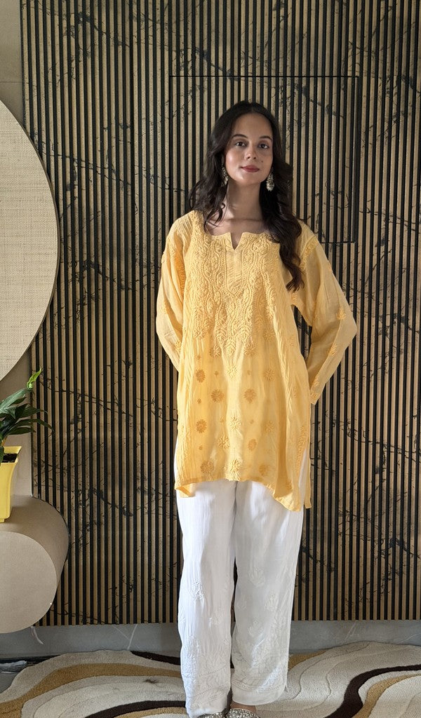 Yellow muslin short kurti on the model
