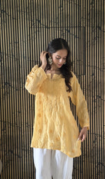 Yellow short kurti, worn by the model