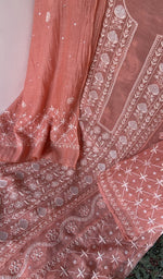Motifs across the body of the coral pink kurta
