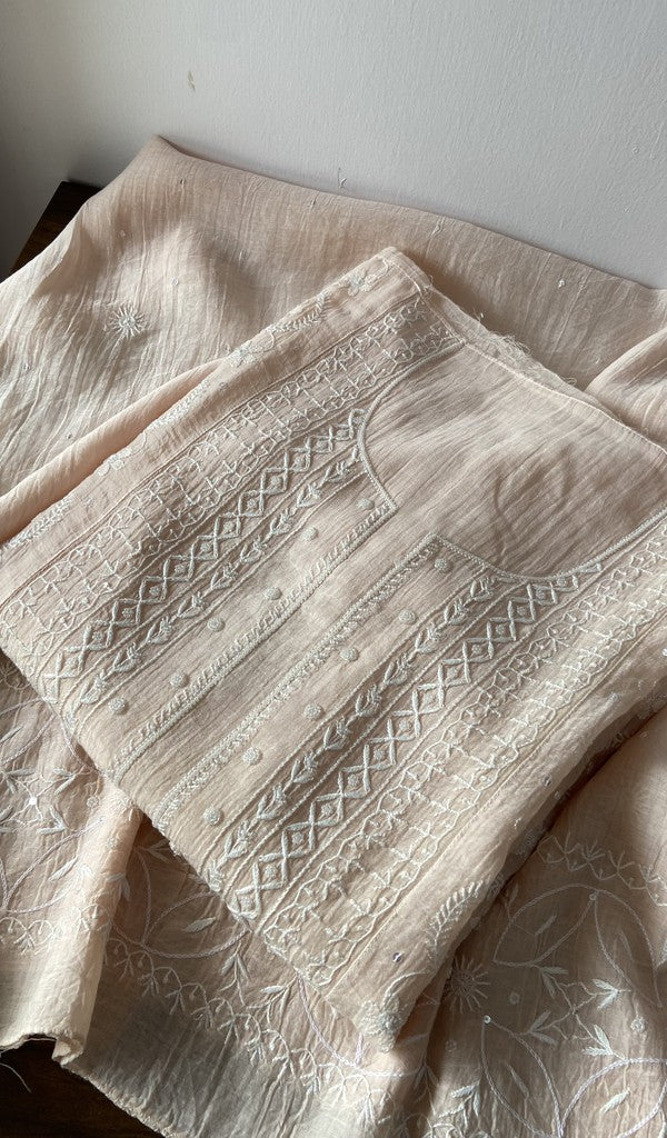 Light peach pure mul chanderi kurta piece folded, fine do taar and teen taar front jaal chikankari