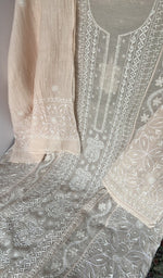 Motifs across the body of the light peach kurta
