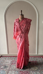 Coral pink tussar silk saree draped on the mannequin, front view