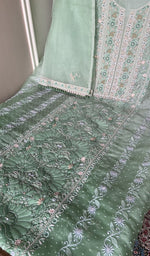 Mint green organza silk laid out flat