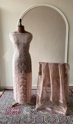 Peach organza silk set on the mannequin with its dupatta