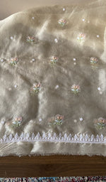 The cream kurta, spread out flat