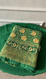Folded stack, green on the carpet